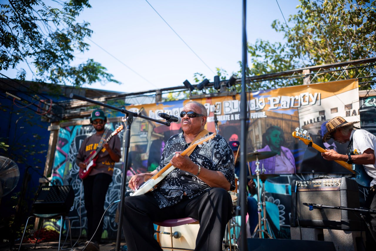 Musicians performing together at an East Austin community gathering
