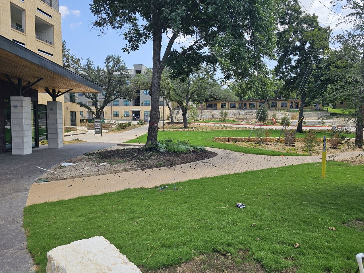 Trees, walking paths, and shared grounds surrounding the WOW Heritage Center