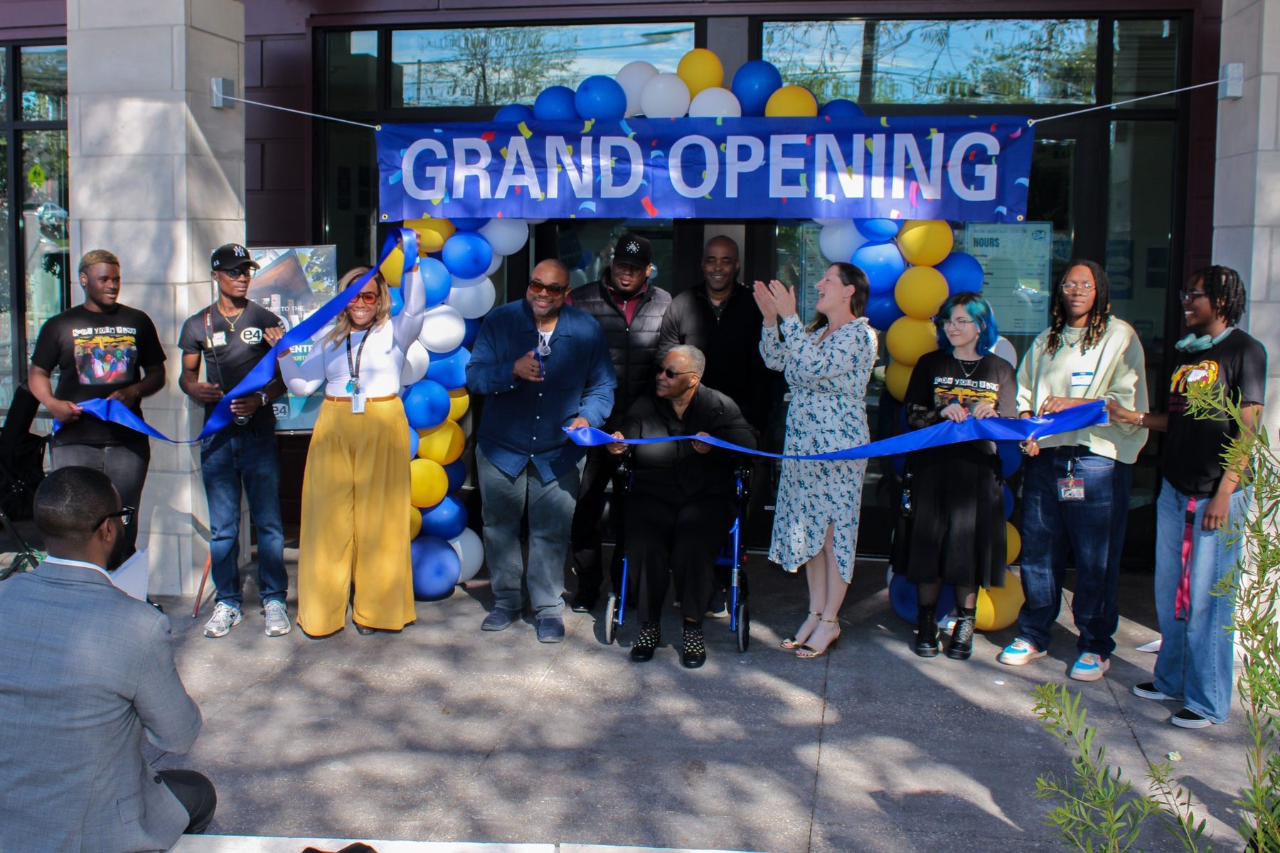 Community members and youth leaders celebrate the WOW Heritage Center ribbon cutting